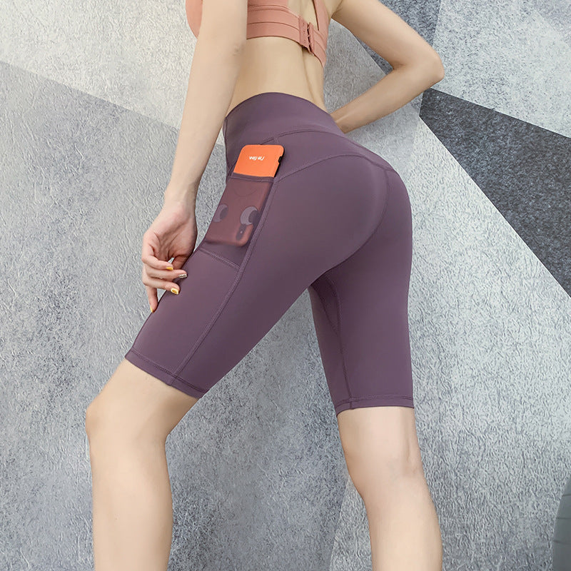 Pantalones de yoga ajustados con cintura alta y secado rápido para correr, de cinco puntos, color melocotón, con realce de cadera y elasticidad.